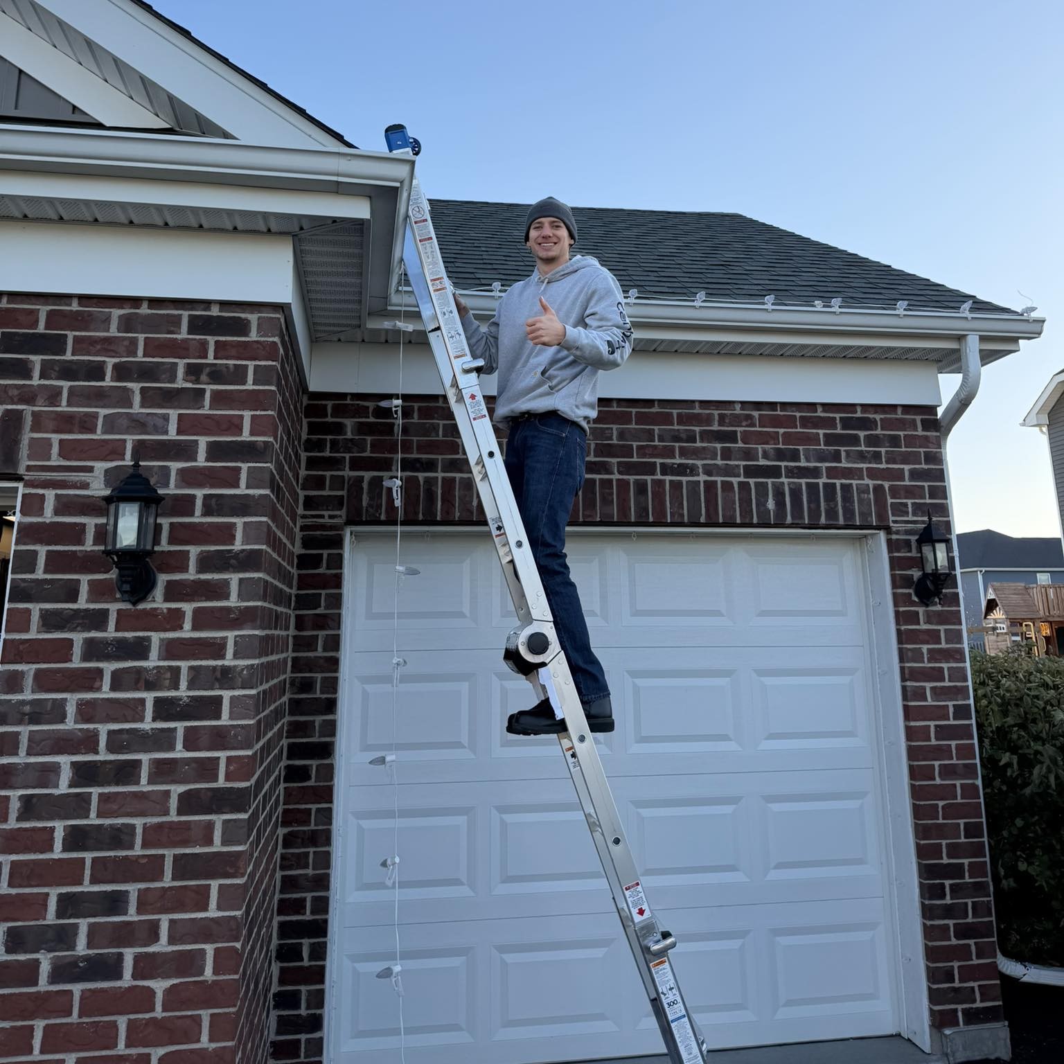 Front of a home illuminated with Christmas lights